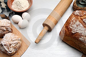 Baking background with cutting board, egg, bread, flour, rolling pin