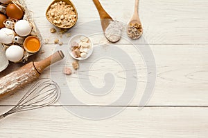 Baking background with eggs and flour on white rustic wood