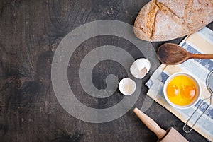 Baking background with eggshell, bread, flour, rolling pin