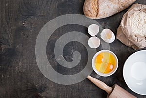 Baking background with eggshell, bread, flour, rolling pin