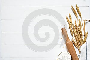 Baking background with flour, wheat ears and rolling pinon concrete background. Top view with copy space
