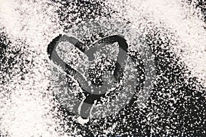 Baking background with heart shape and flour on the dark table. Copy space for text
