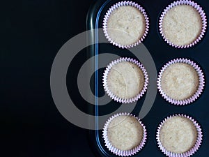 Baking banana cake. Homemade healthy banana cake made with oat flour in cup prepare for bake on black background