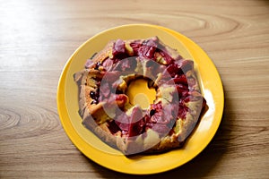 Baking and berries on a wooden background with flowers.