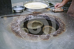 Baking bread cakes in a clay oven. Out of a traditional brick oven