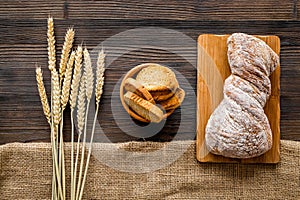 Baking bread with wheat flour and ears on table rystic background top view