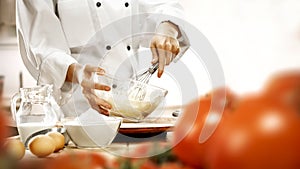Baking a cake and bread. Chefâ€™s female hands preparing food in the kitchen. Woman in white chef uniform.