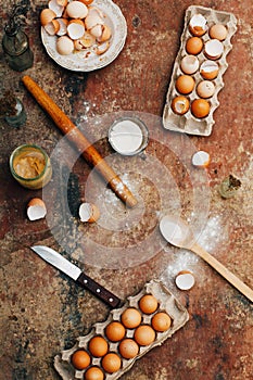 Baking cake ingredients - bowl, flour, eggs, egg whites foam, eggbeate on wood chalkboard from above. Cooking course or kitchen m