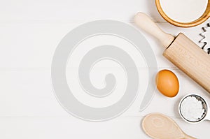 Baking cake or pizza ingredients top view on wooden background