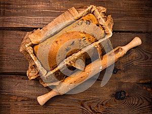 Baking cake with rolling pin on rural rustic wooden background flat lay. Dough recipe ingredients eggs wholegrain flour