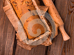 Baking cake with rolling pin on rural rustic wooden background flat lay. Dough recipe ingredients eggs wholegrain flour