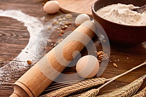 Baking chocolate cake in rural or rustic kitchen. Dough recipe ingredients on vintage wood table