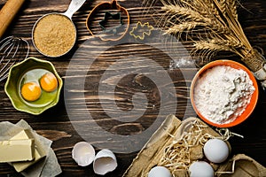 Baking concept - baking ingredients butter, flour, sugar, eggs on rustic wood background