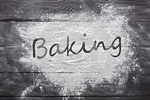 Baking concept on wood background, sprinkled flour with copy space
