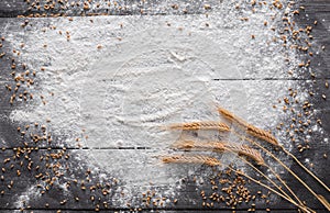 Baking concept on wood background, sprinkled flour with copy space