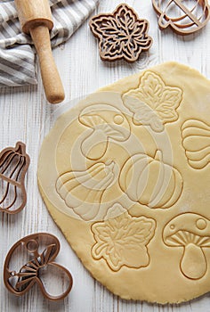 Baking cookies in the form of pumpkin and leaves