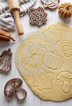 Baking cookies in the form of pumpkin and leaves