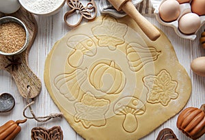 Baking cookies in the form of pumpkin and leaves