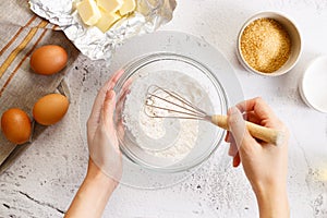 Baking and cooking ingredients on white marble background
