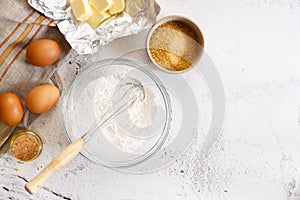 Baking and cooking ingredients on white marble background