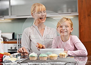Baking, cupcake and portrait with child and mom in kitchen to relax in home together on holiday. Family, bonding and kid