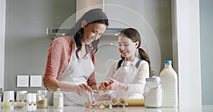 Baking, family and a mother with her daughter learning about cooking in a kitchen for child development. Bake, kids and