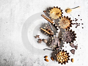 Baking ingredients: brown sugar, cocoa, almond, dark chocolate and spices on gray marble background. Top view