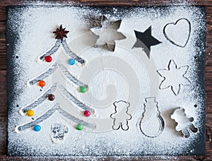 Baking ingredients for Christmas cookies on a dark table, ingredients for baking on dark background, top view