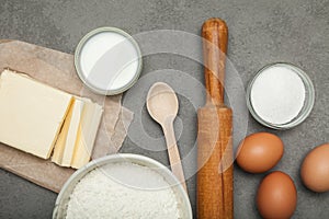 Baking ingredients: egg and flour on grey background, dough preparation