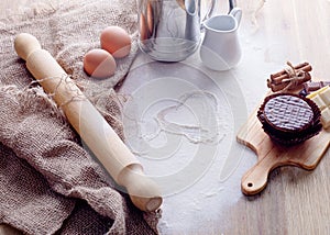 baking ingredients egg, flour, oil and muffin for baking on wooden background