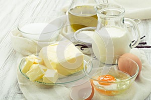 Baking ingredients eggs, flour, sugar, butter, vanilla, cream