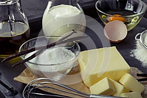 Baking ingredients eggs, flour, sugar, butter, vanilla, cream photo