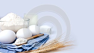 Baking ingredients. Flour, eggs, milk and sugar on the white background. Cooking process. Close-up. Copy space