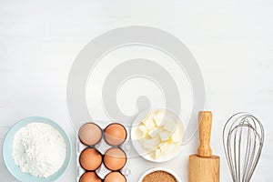 Baking ingredients and kitchen utensils on white background