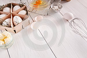 Baking ingredients on white rustic wood background, copy space