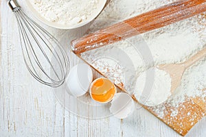 Baking ingredients on white wooden background