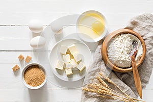 Baking ingredients on white wooden table background