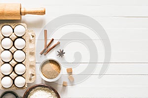 Baking ingredients on white wooden table background