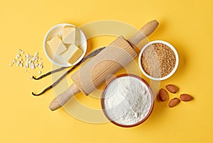 Baking ingredients on yellow background