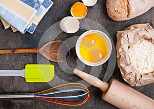 Baking kitchen utensils on vintage planked wood table from above