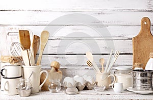 Baking kitchenware and baking products on white wooden background