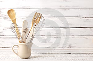 Baking kitchenware and baking products on white wooden background