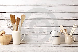 Baking kitchenware and baking products on white wooden background