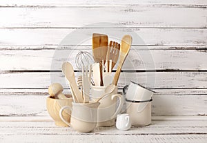 Baking kitchenware and baking products on white wooden background