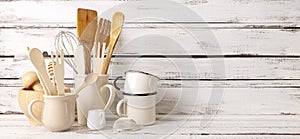 Baking kitchenware and baking products on white wooden background