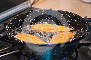 Baking panzerotti, chebureks, kutabs pies in vegetable oil