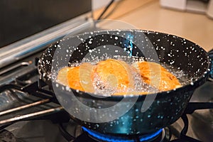 Baking panzerotti, chebureks, kutabs pies in vegetable oil