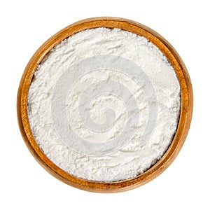 Baking powder, chemical leavening agent in a wooden bowl