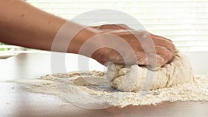Baking process. Woman hands kneading whole wheat flour bread dough