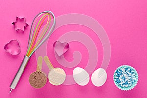 Baking protein, eggs and cookie cutter on pink background